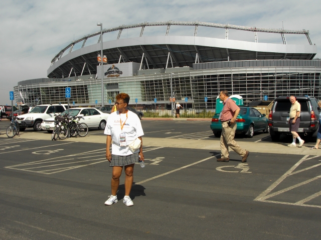 Me standing in front of the INVESCO Stadium parking lot